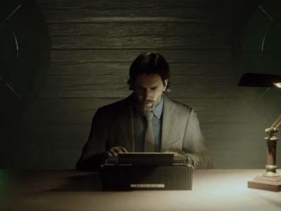 Alan Wake Sitting Behind A Desk